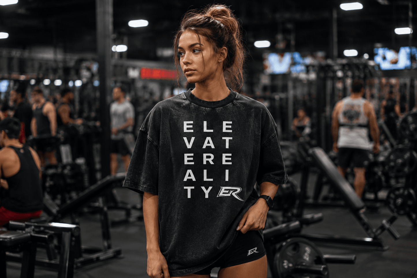 Woman training inside a gym wearing a black oversized Short Sleeve Pump Cover