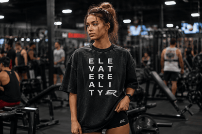 Woman training inside a gym wearing a black oversized Short Sleeve Pump Cover