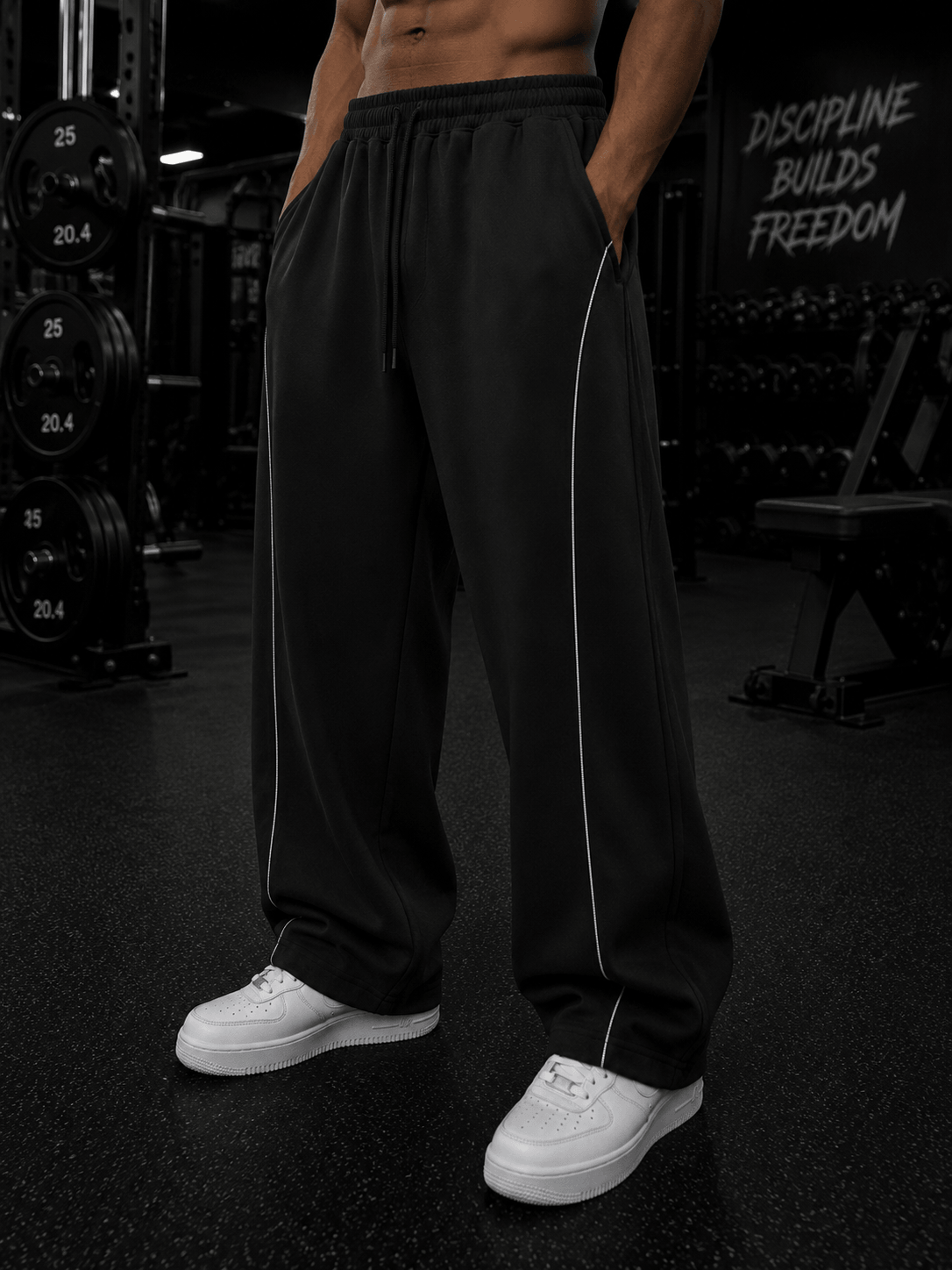 Elevate Single Stripe Sweatpants in black, perfect for casual and sporty looks, styled with white sneakers.