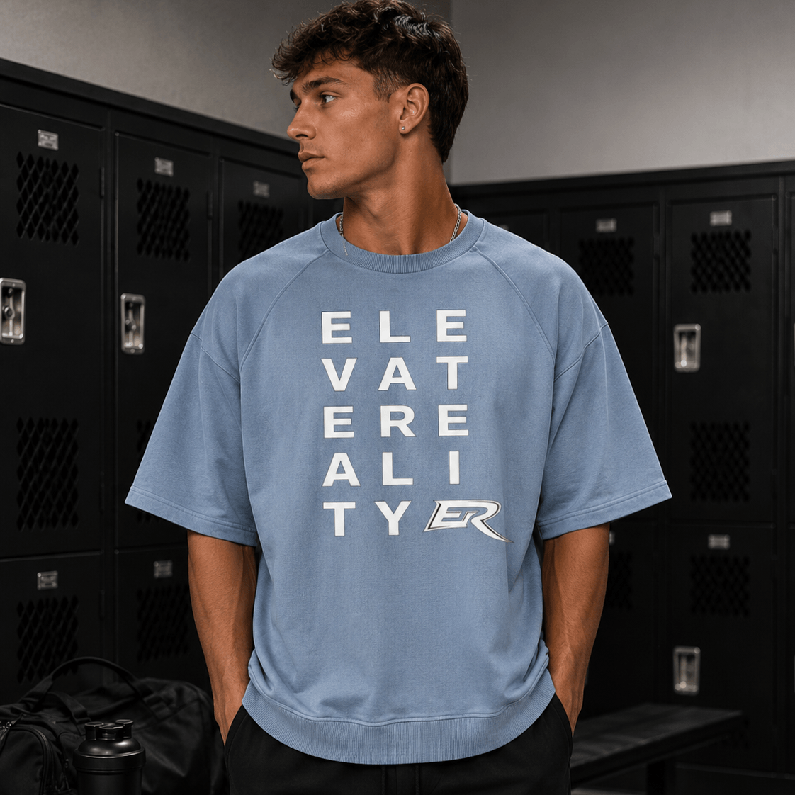 Man wearing light blue heavy cotton Short Sleeve Pump Cover with block letter logo graphic in gym locker room