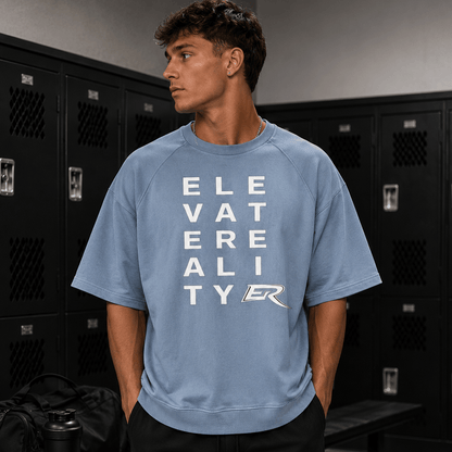 Man wearing light blue heavy cotton Short Sleeve Pump Cover with block letter logo graphic in gym locker room