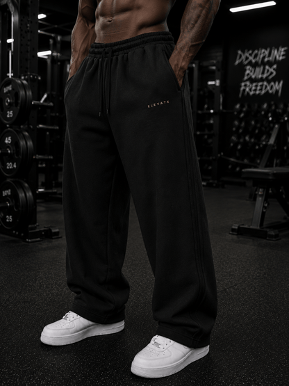 A model showcasing Elevate Sweats in black cotton fabric, featuring a casual design perfect for sporty or daily wear.