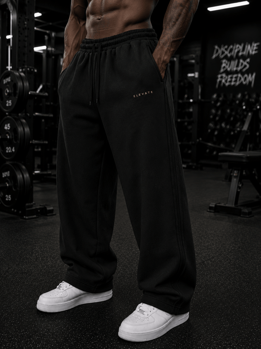A model showcasing Elevate Sweats in black cotton fabric, featuring a casual design perfect for sporty or daily wear.