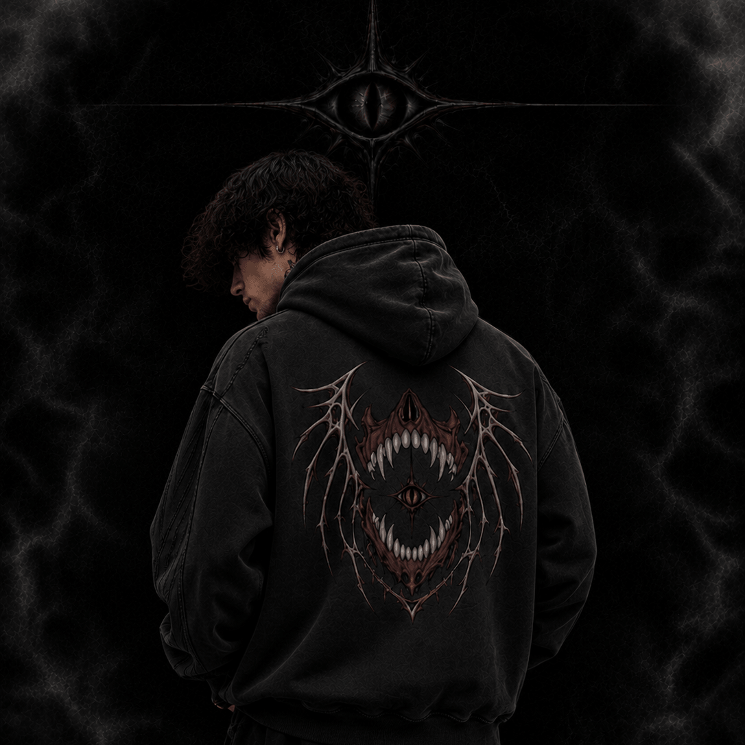 Person wearing a black hoodie with a design on the back against a dark background, featuring 'The Witness Collection' branding.