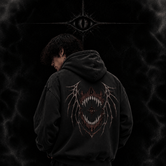 Person wearing a black hoodie with a design on the back against a dark background, featuring 'The Witness Collection' branding.
