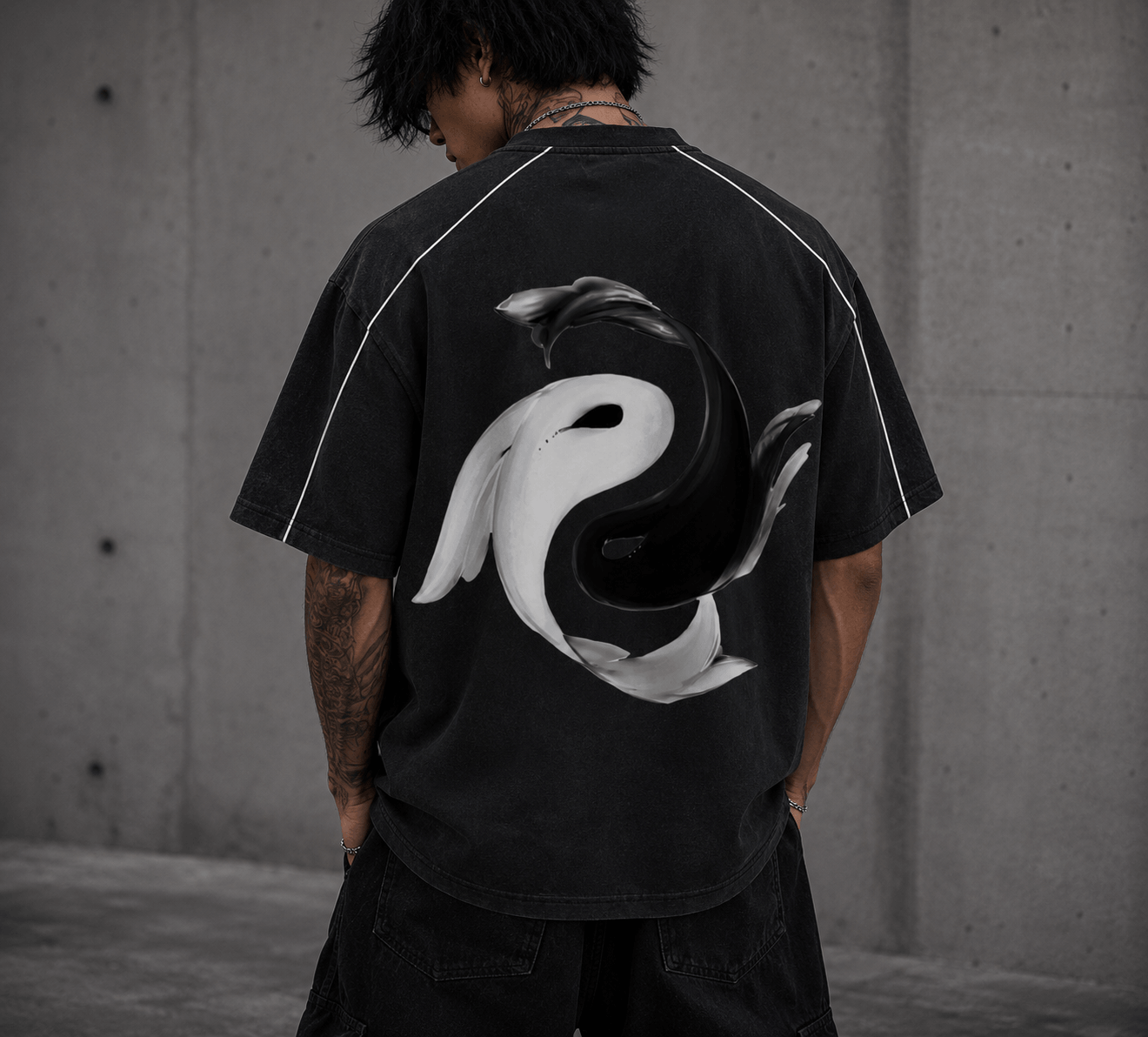 Yin Yang Pump Cover with a bold graphic design on the back worn by a person in a black oversized tee.