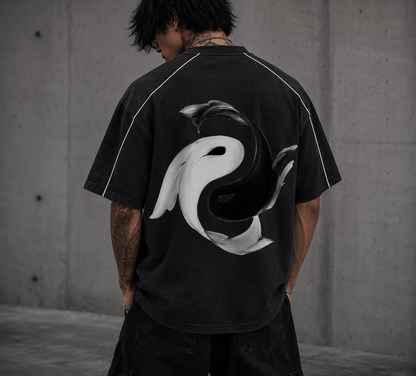 Yin Yang Pump Cover with a bold graphic design on the back worn by a person in a black oversized tee.