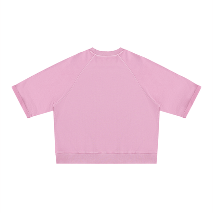 Woman wearing matching pink Short Sleeve Pump Cover and athletic shorts set front view